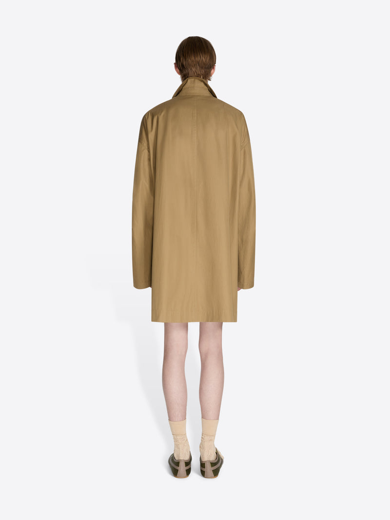 Person wearing a beige trench coat on a white background - Dries Van Noten