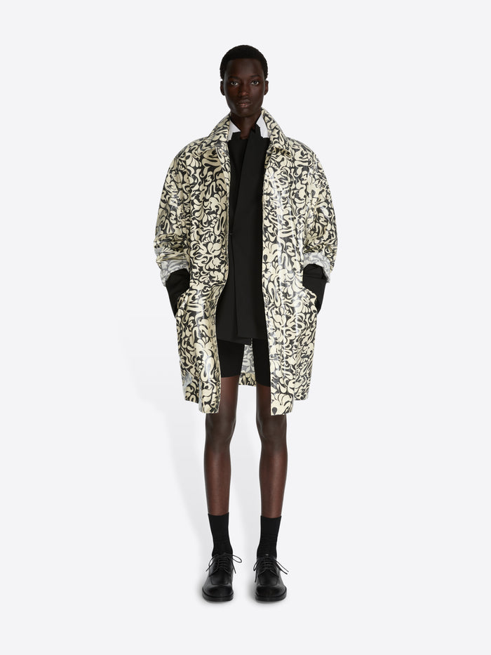 Person wearing a patterned coat on a white background - Dries Van Noten
