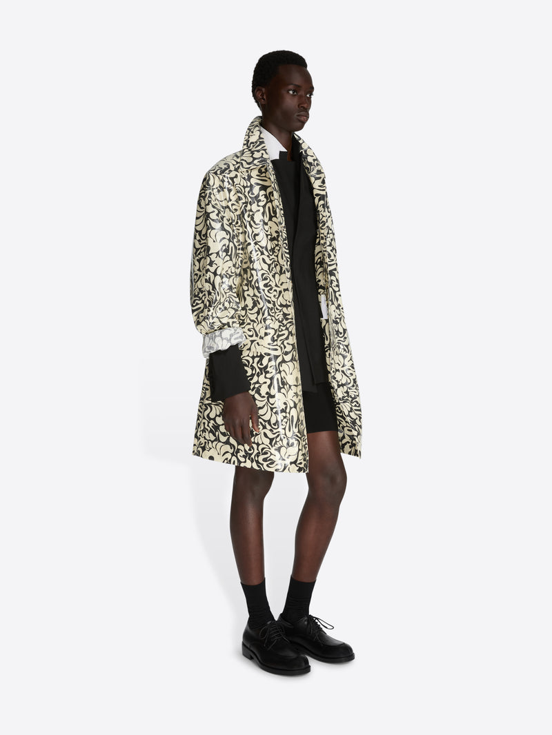 Person wearing a patterned coat on a white background - Dries Van Noten