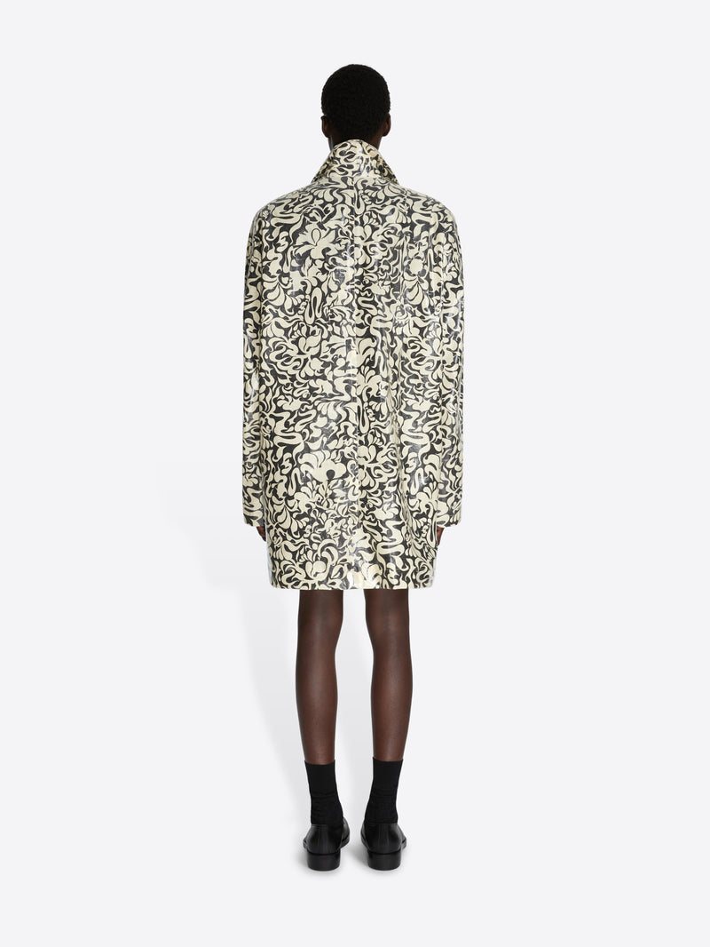 Person wearing a patterned coat on a white background - Dries Van Noten