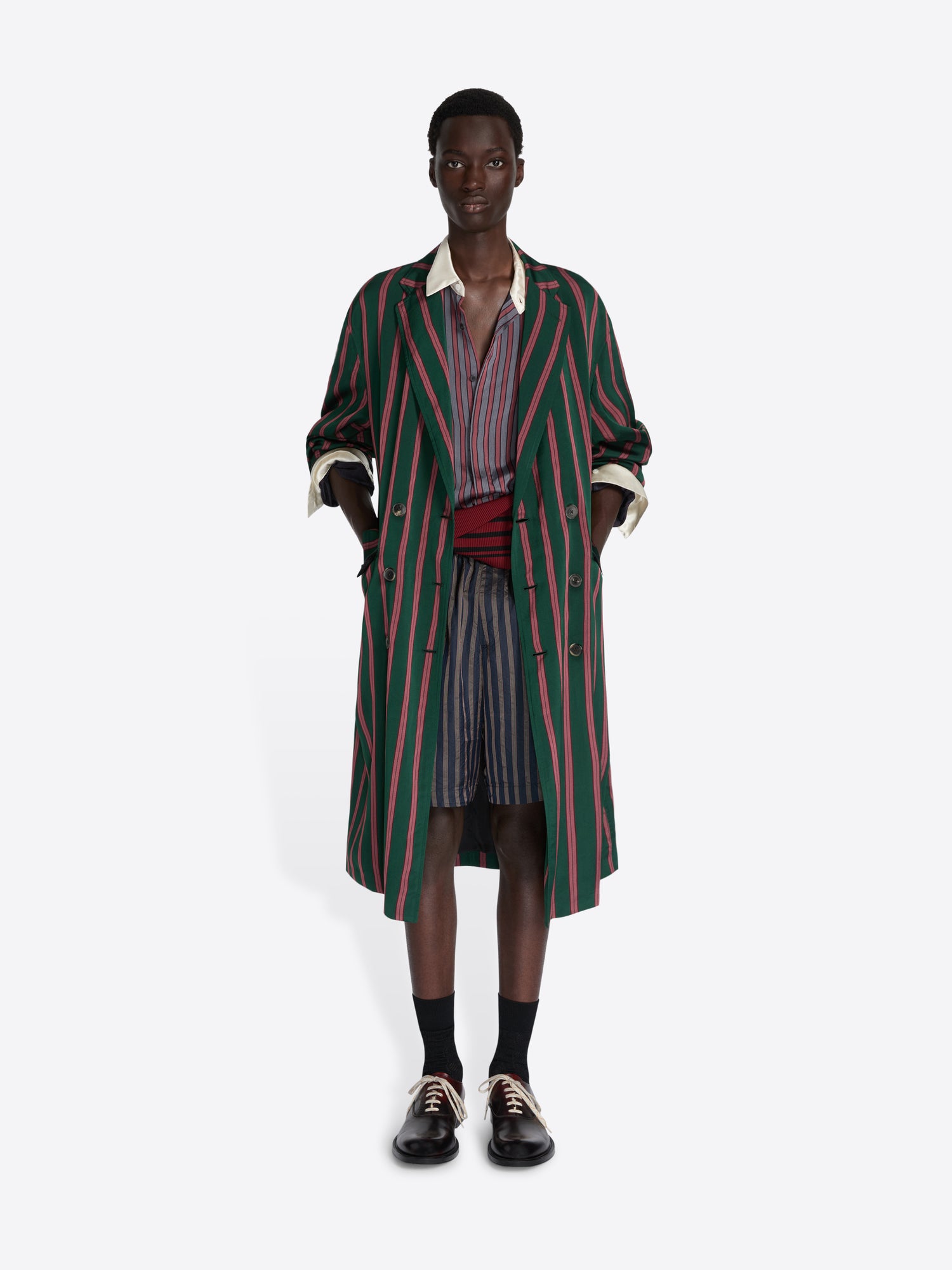 Person wearing a striped coat on a white background - Dries Van Noten