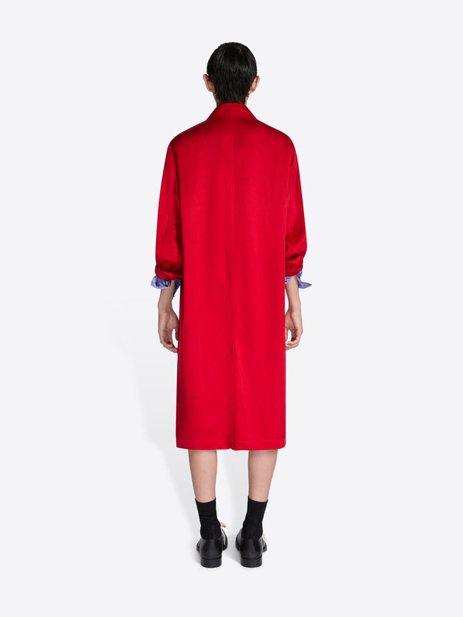 Person wearing a red coat with long sleeves on a white background