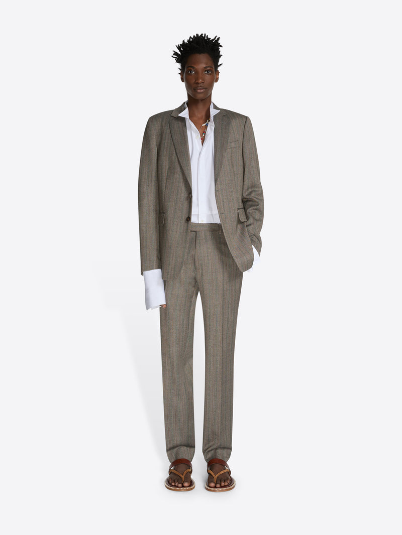 Man wearing a beige suit with a white shirt on a white background