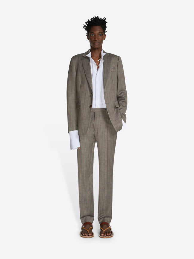 Man wearing a beige suit with a white shirt on a white background