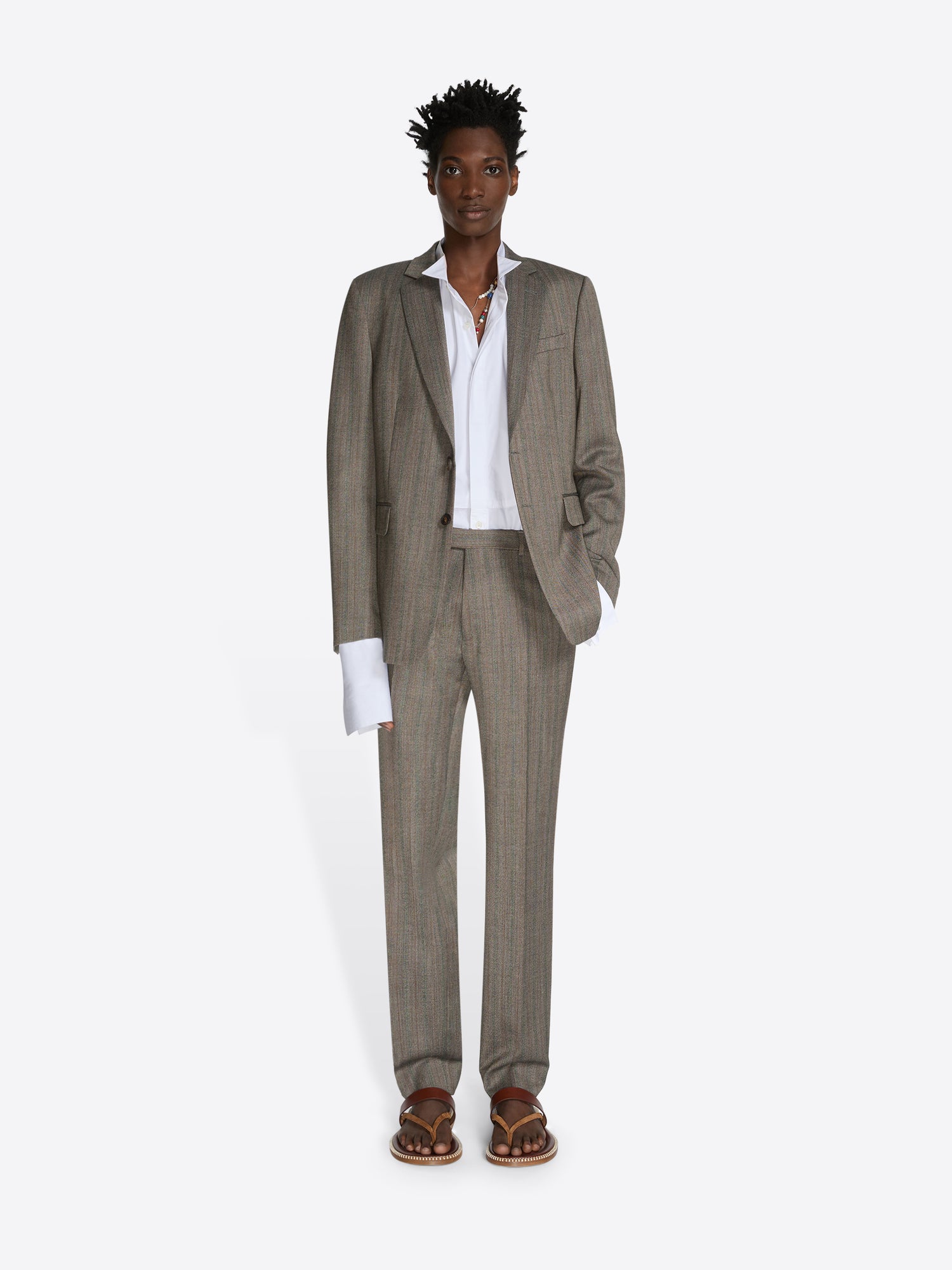 Man wearing a beige suit with a white shirt on a white background