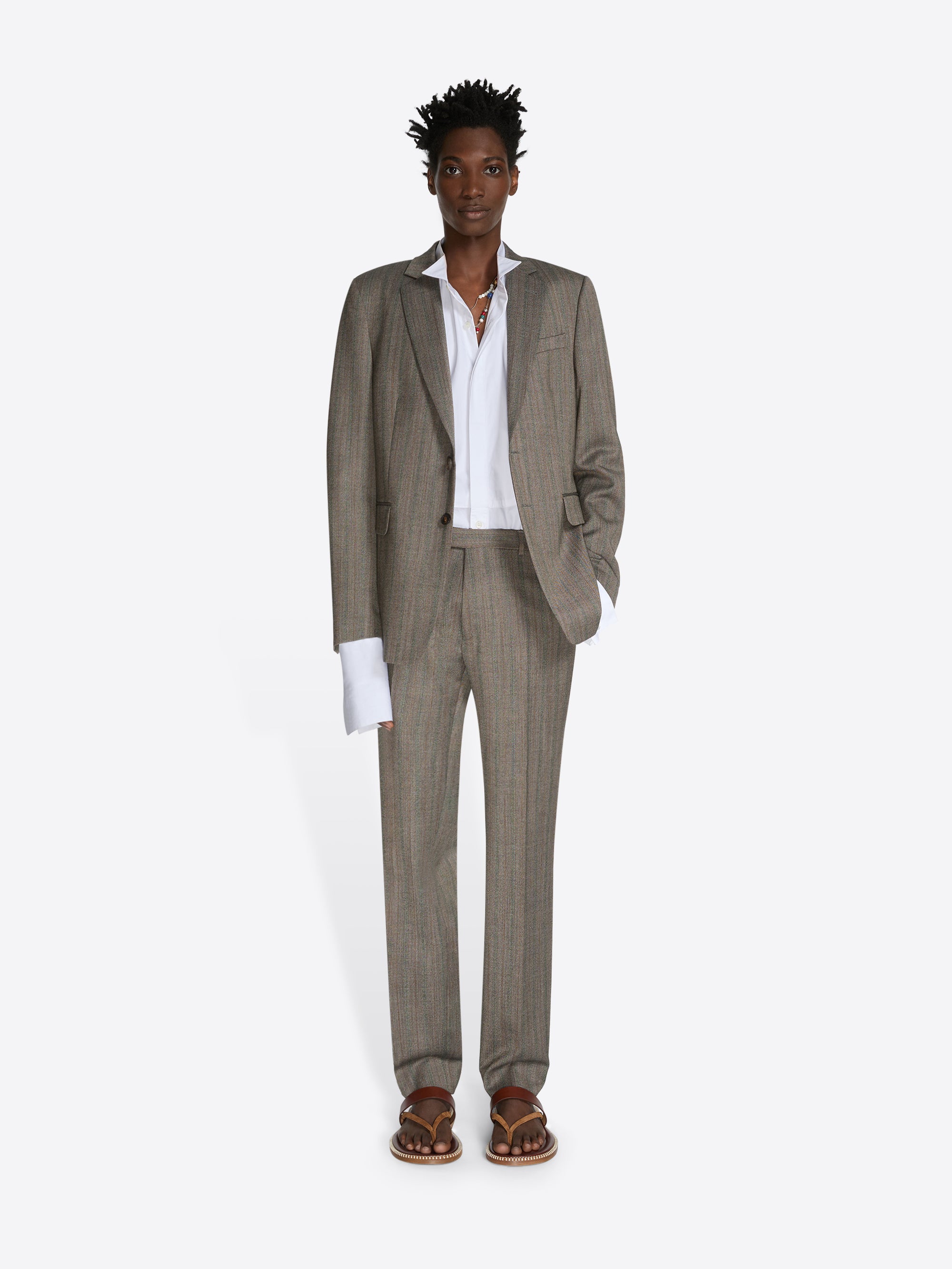 Man wearing a beige suit with a white shirt on a white background