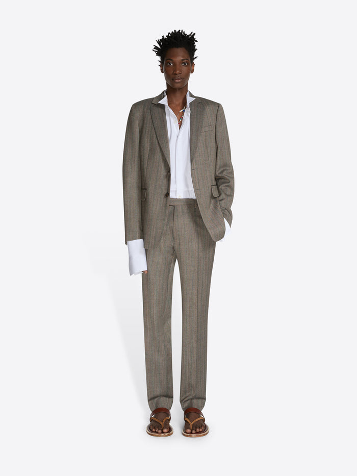 Man wearing a beige suit with a white shirt on a white background