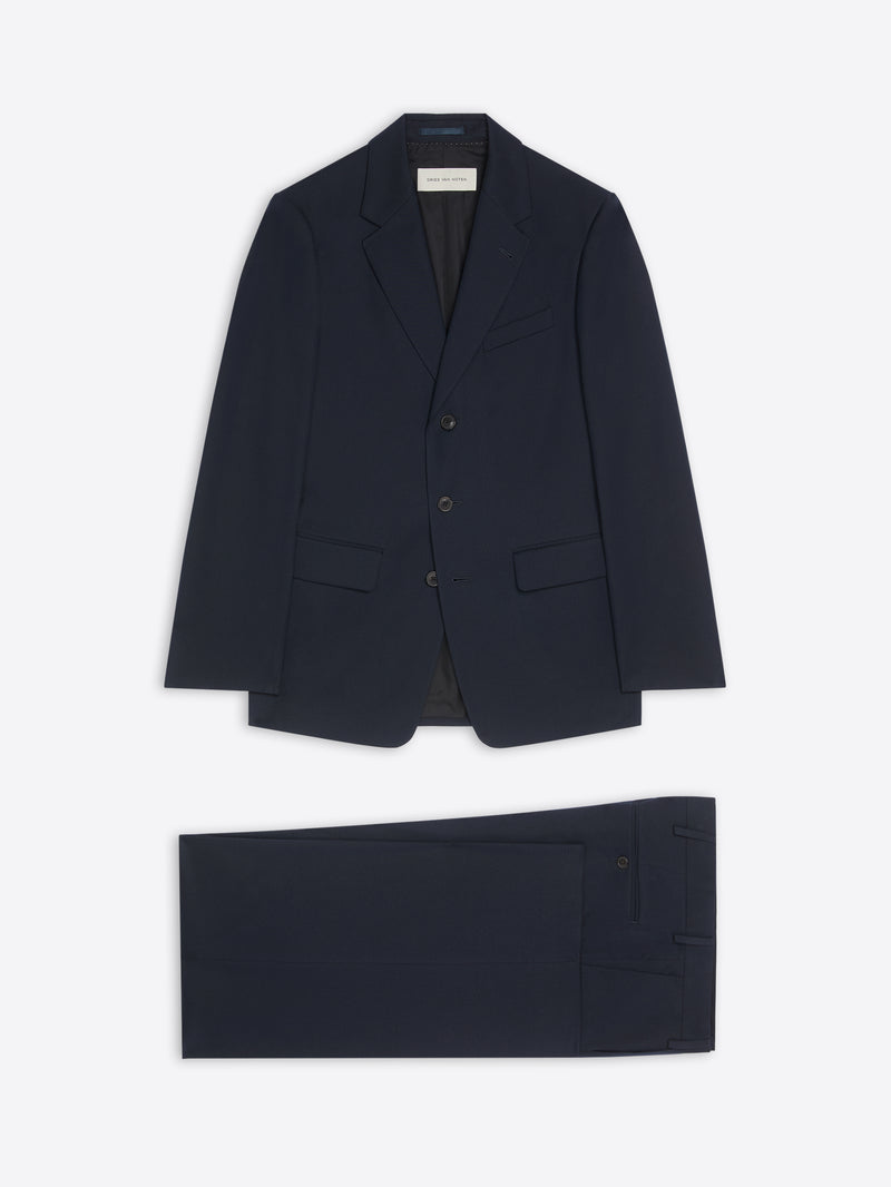 Navy blue suit jacket and pants on a white background
