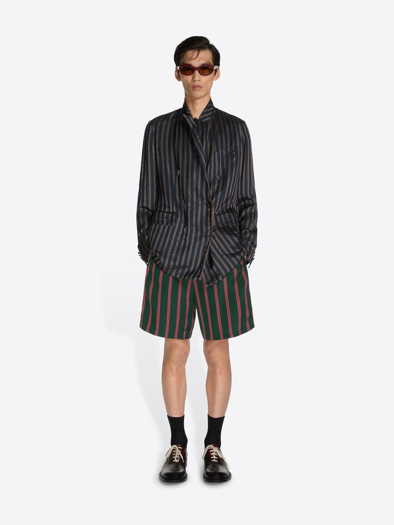Person wearing a striped shirt and shorts on a white background - Dries Van Noten