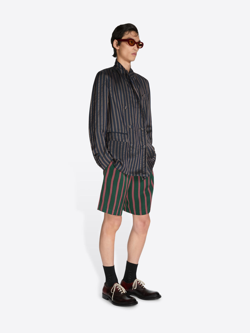 Person wearing a striped shirt and shorts on a white background - Dries Van Noten