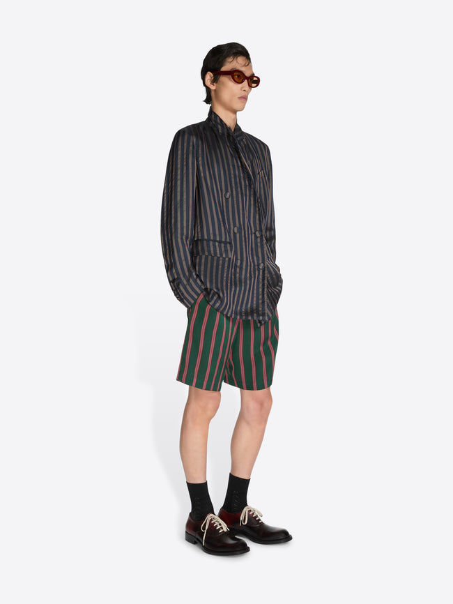 Person wearing a striped shirt and shorts on a white background - Dries Van Noten