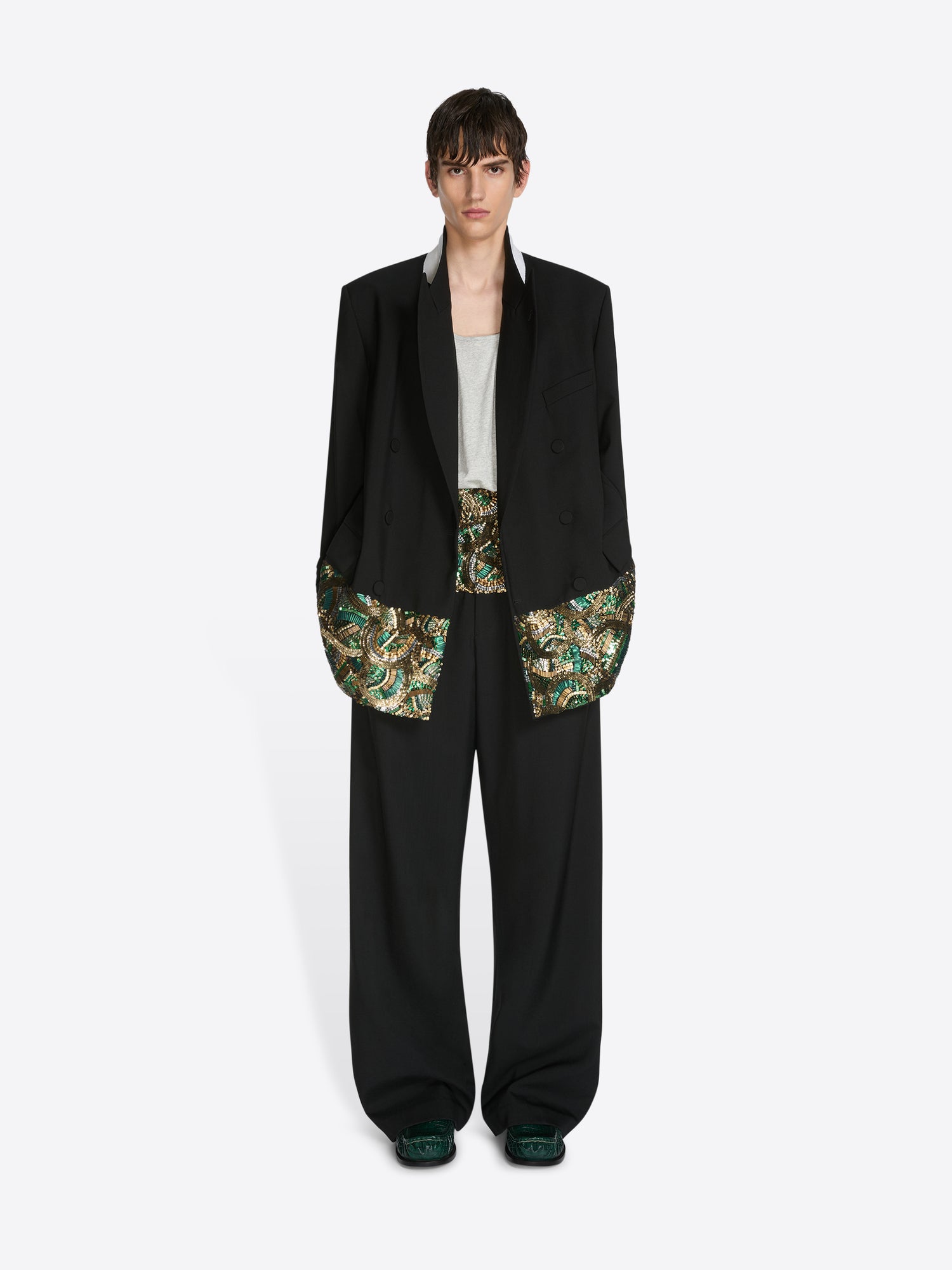 Person wearing a black blazer with floral patterns on a white background - Dries Van Noten