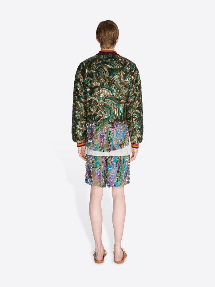 Person wearing a patterned outfit on a white background - Dries Van Noten
