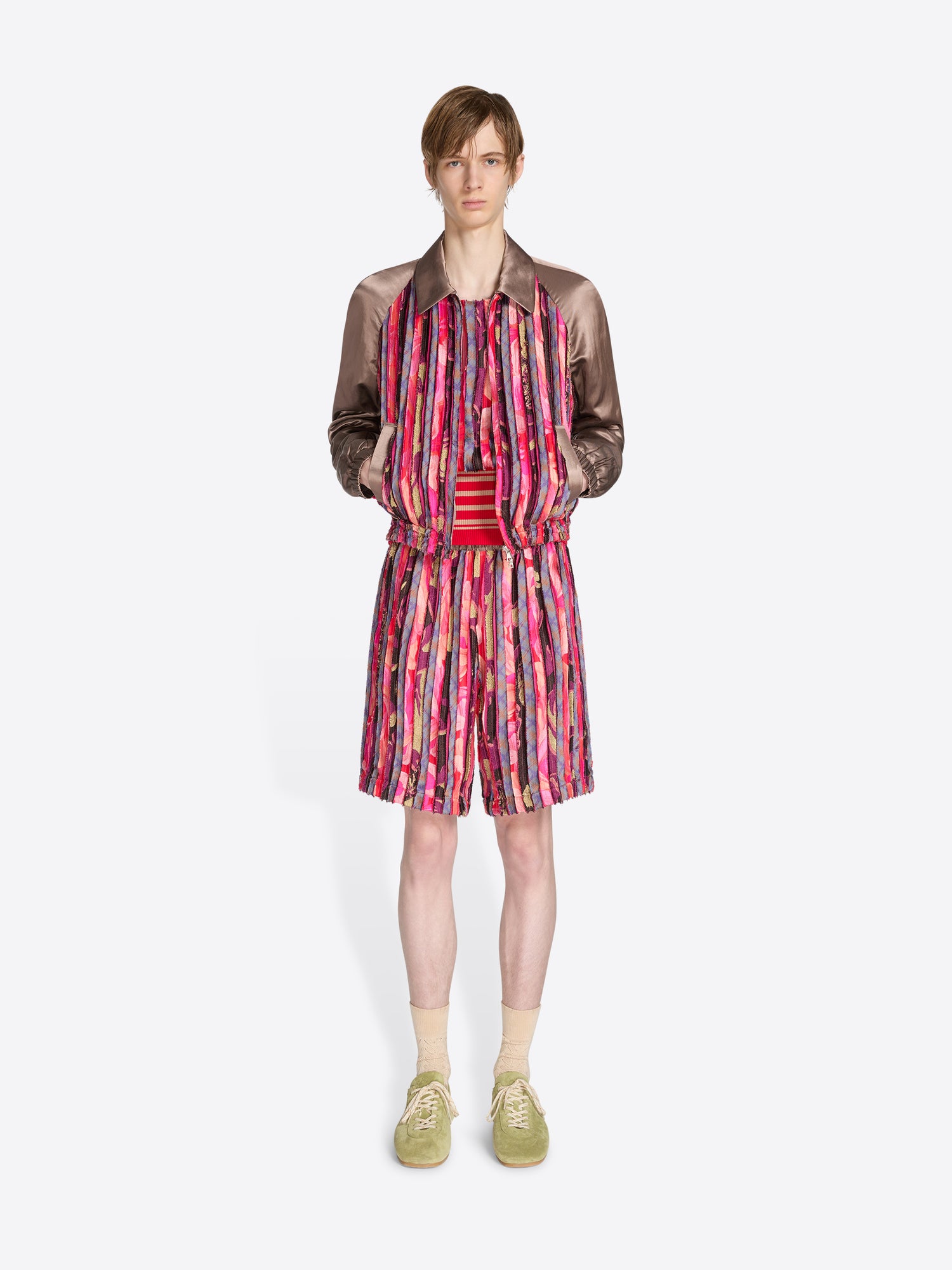 Model wearing a colorful dress with a patterned jacket on a white background - Dries Van Noten