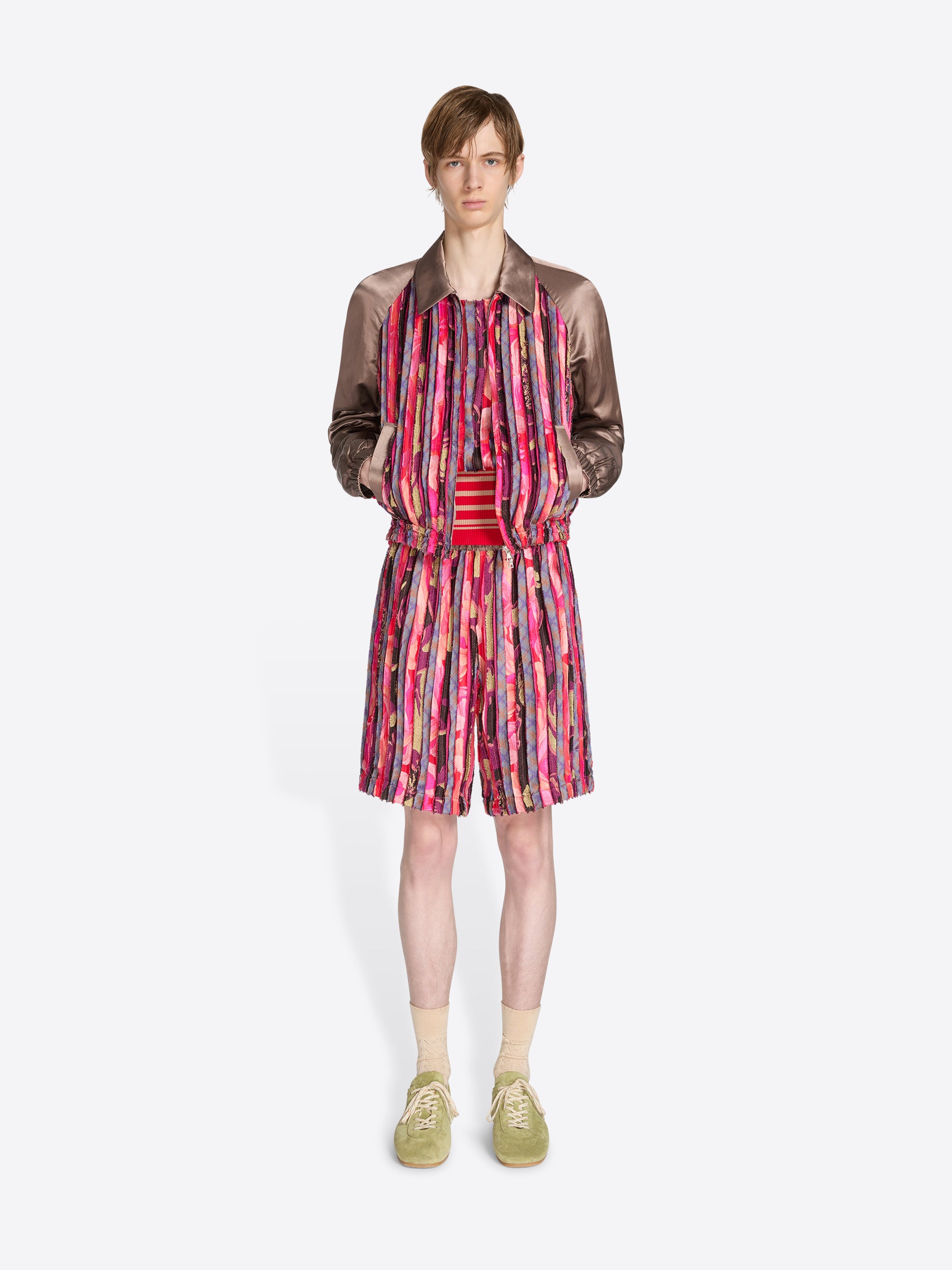 Model wearing a colorful dress with a patterned jacket on a white background - Dries Van Noten