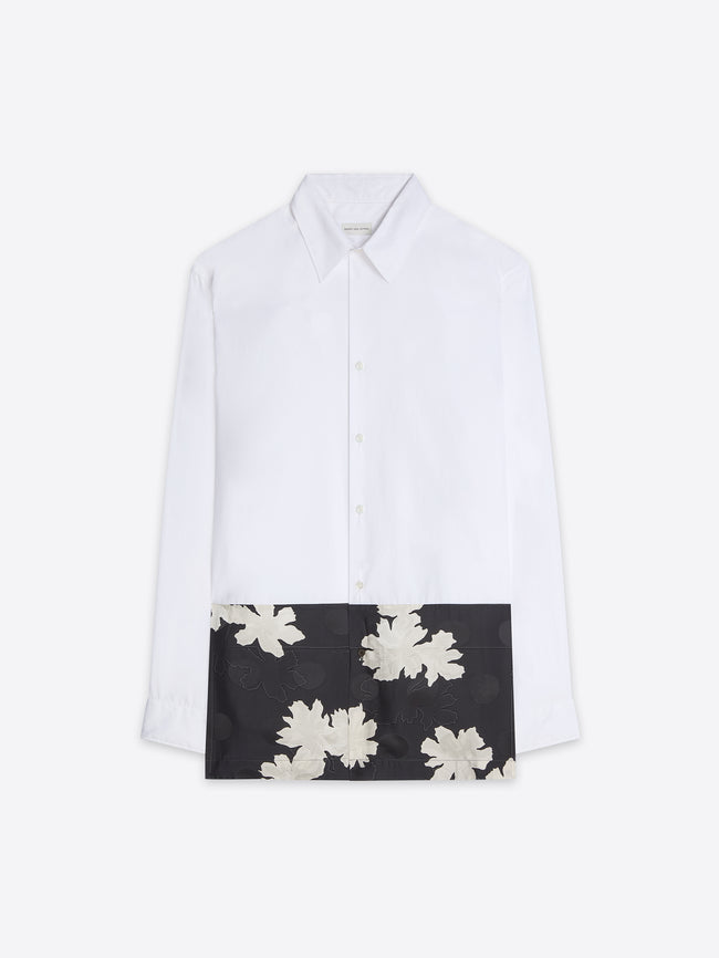 White shirt with a black panel featuring white floral patterns on a white background