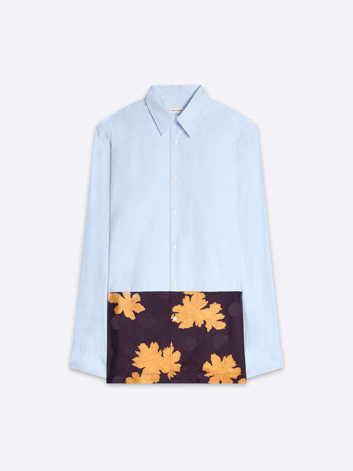 Light blue shirt with a dark panel featuring yellow floral patterns on a white background