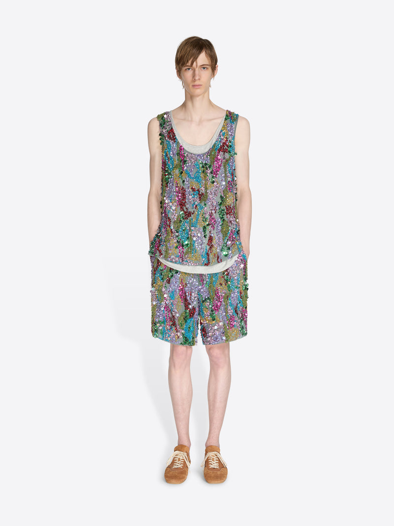 Person wearing a colorful sleeveless top and shorts on a white background - Dries Van Noten