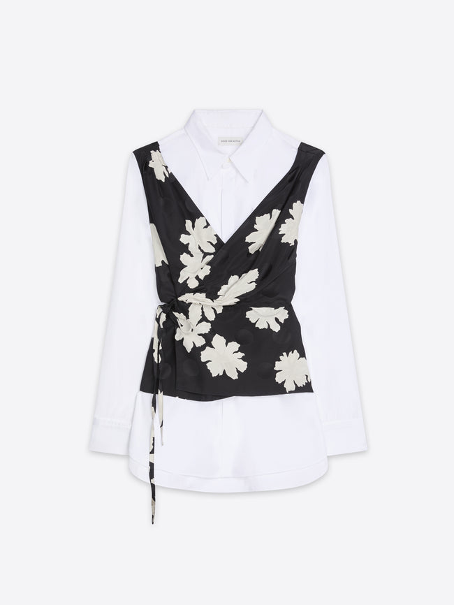 White blouse with a black floral wrapover design on a white background