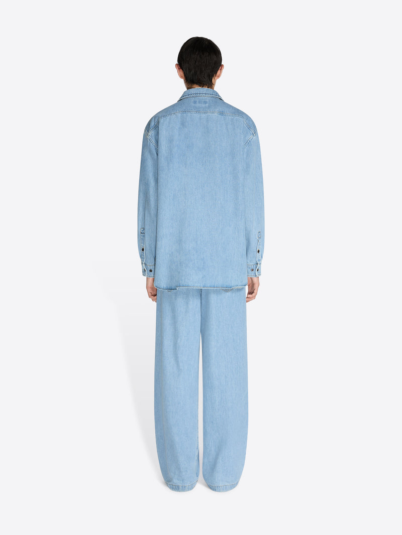 Person wearing a light blue denim outfit on a white background - Dries Van Noten