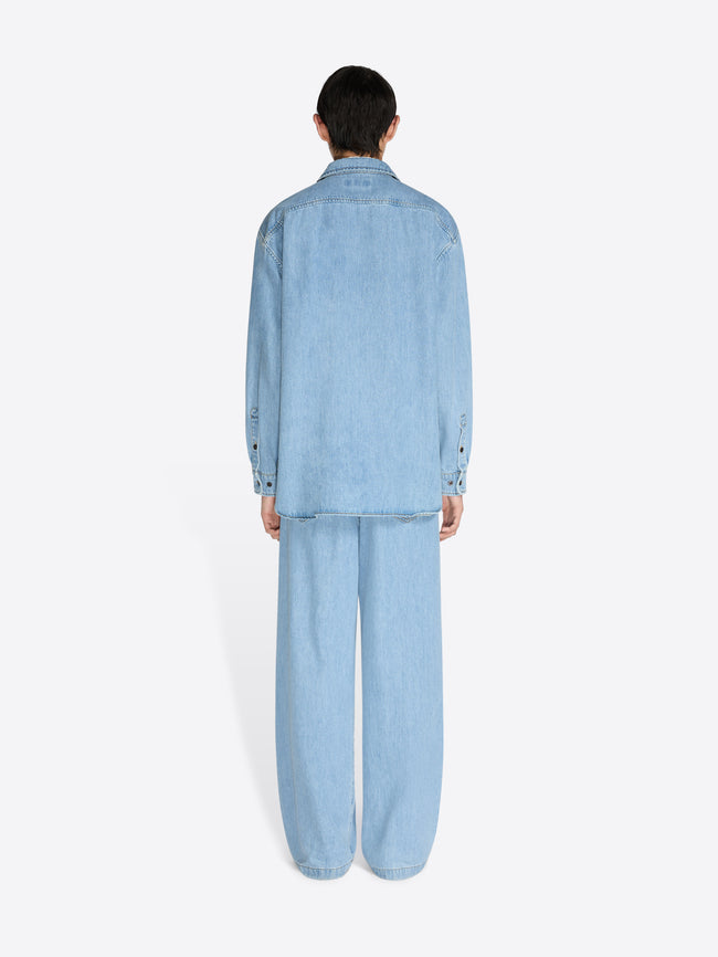 Person wearing a light blue denim outfit on a white background - Dries Van Noten