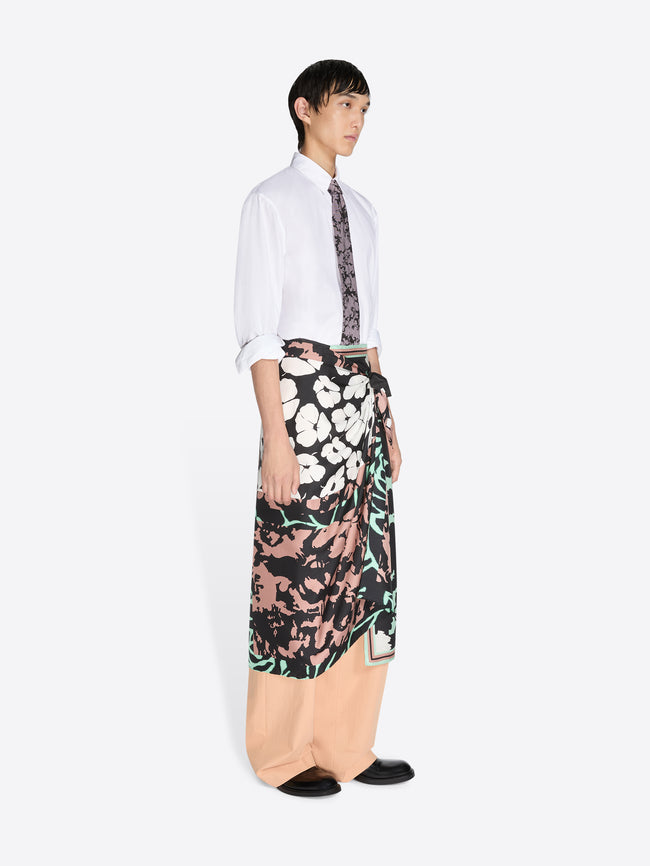 Person wearing a patterned outfit on a white background.