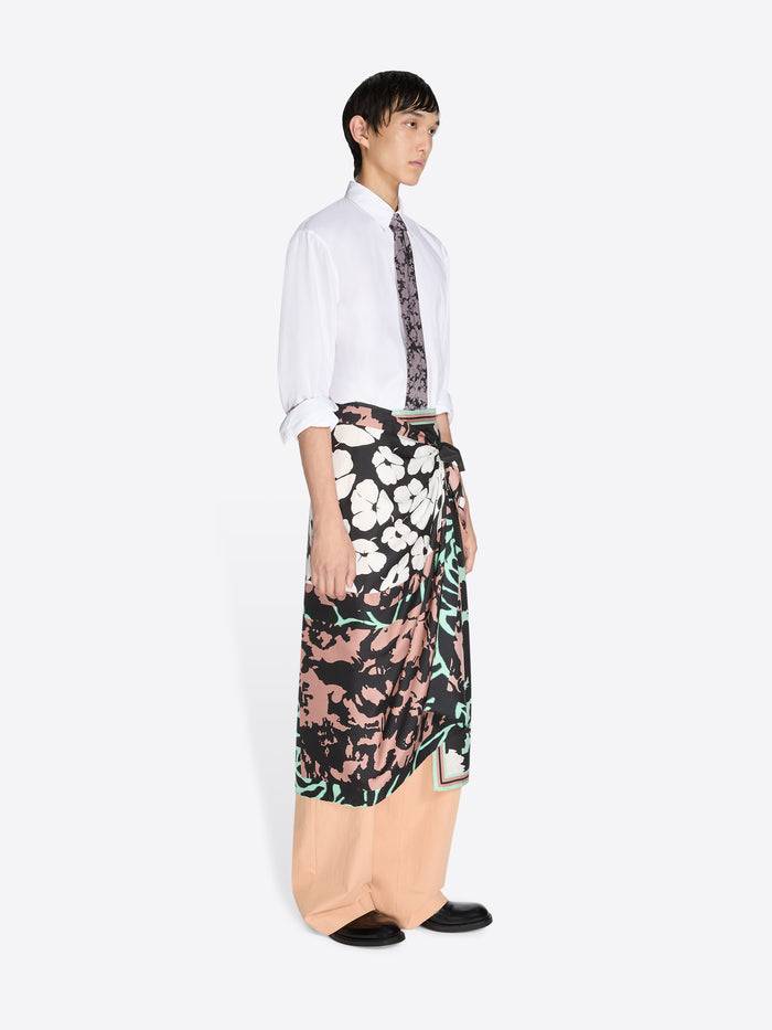 Person wearing a patterned outfit on a white background.