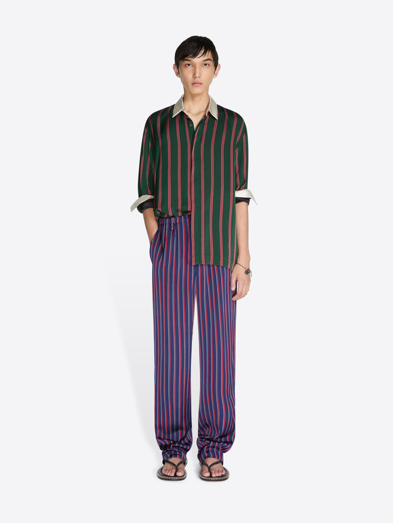 Person wearing a striped shirt and pants on a white background - Dries Van Noten