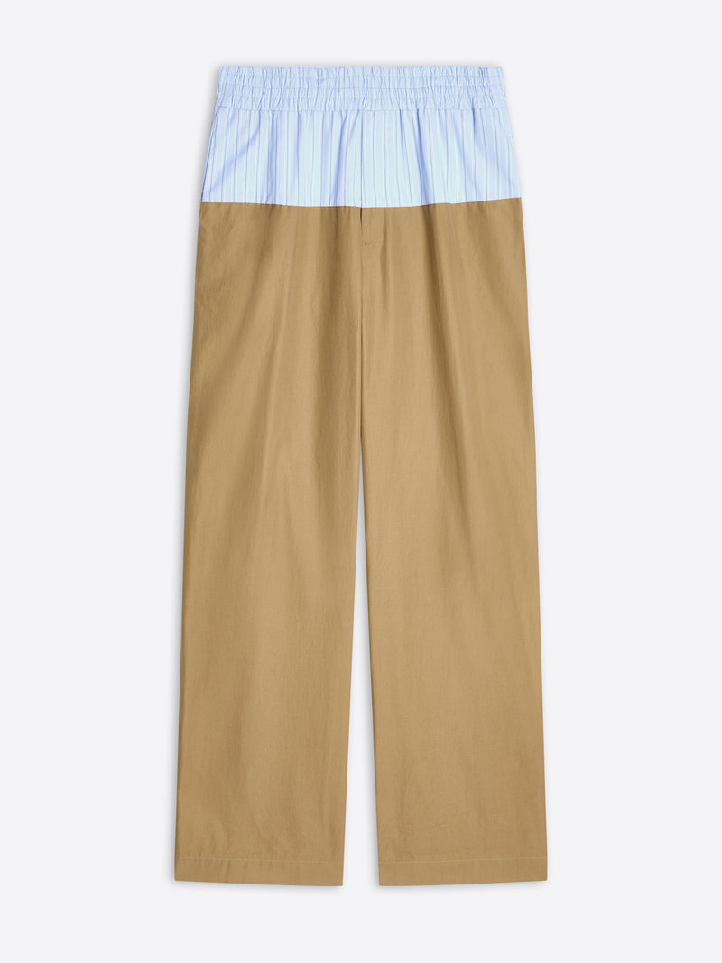 Beige pants with a light blue top section on a white background