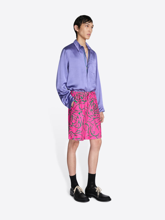 Person wearing a purple shirt and pink skirt with a white background - Dries Van Noten
