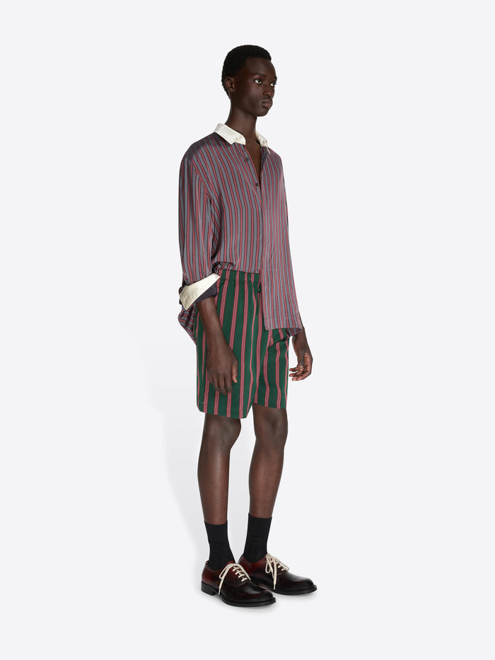 Man wearing a striped shirt and shorts on a white background - Dries Van Noten