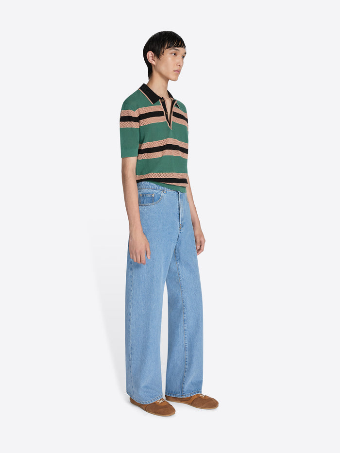 Person wearing a striped shirt and jeans on a white background