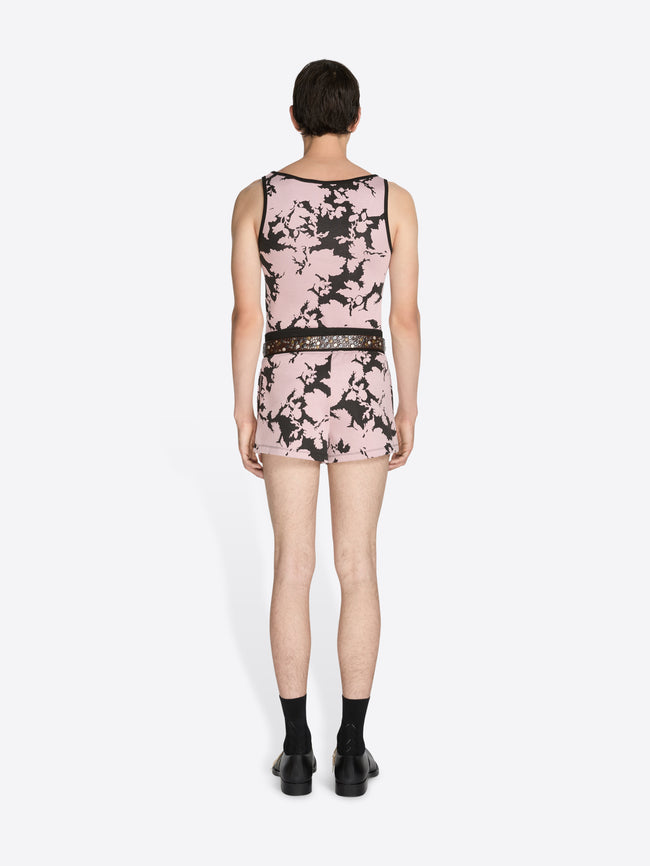 Person wearing a sleeveless floral set on a white background