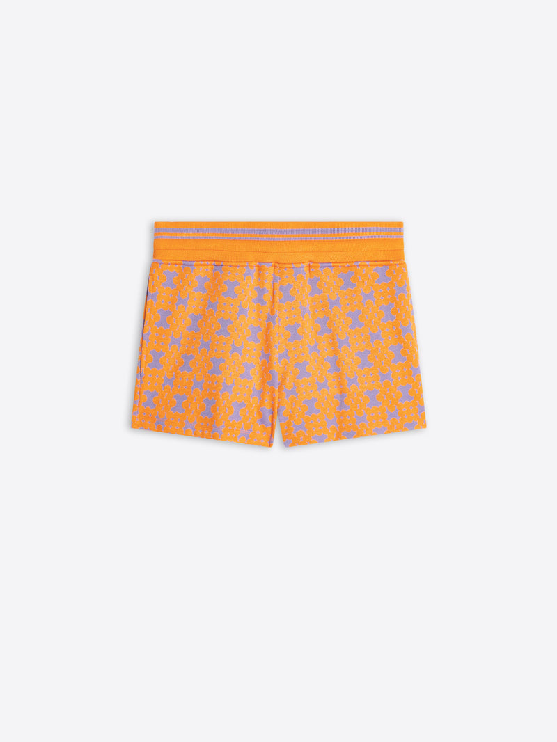 Orange shorts with a pattern on a white background
