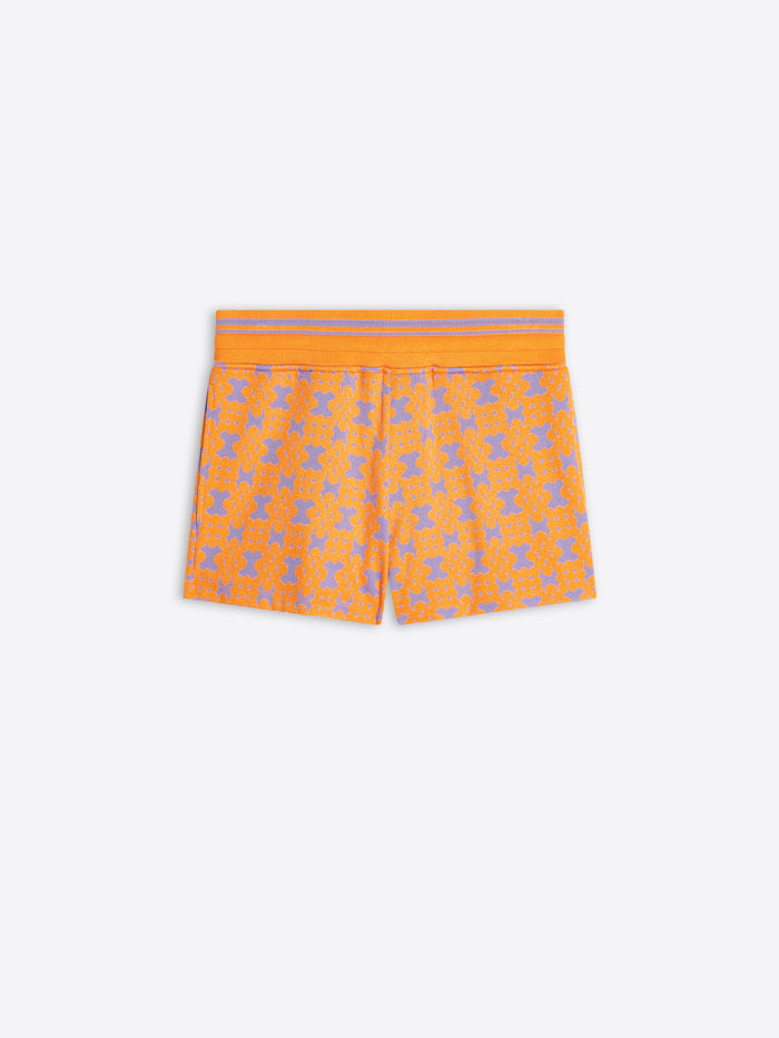 Orange shorts with a pattern on a white background