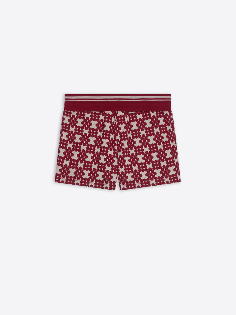 Red and white patterned shorts on a white background