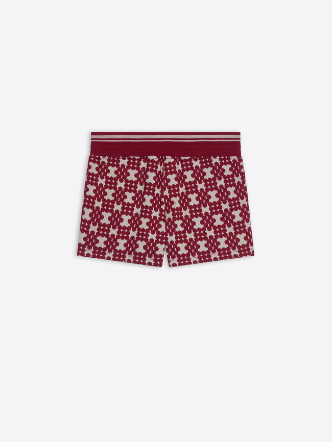 Red and white patterned shorts on a white background