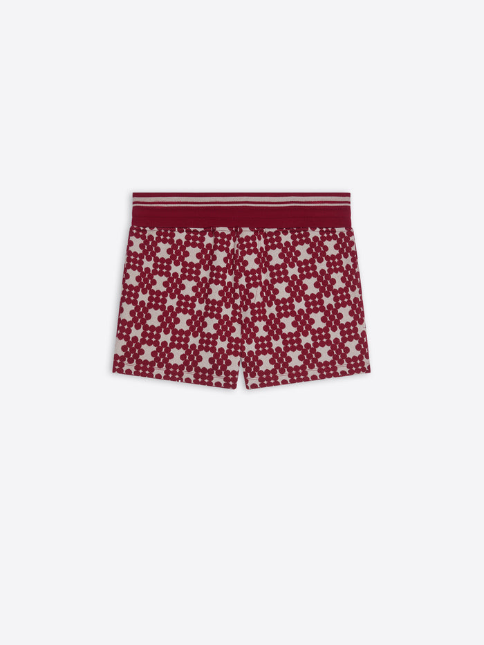 Red and white patterned shorts on a white background