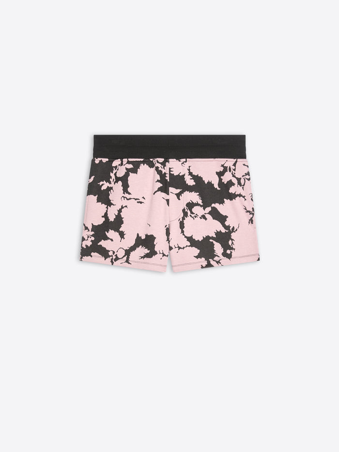 Pink and black floral shorts on a white background