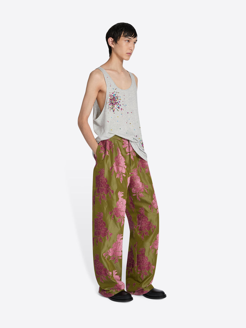 Person wearing a sleeveless top and floral pants on a white background - Dries Van Noten