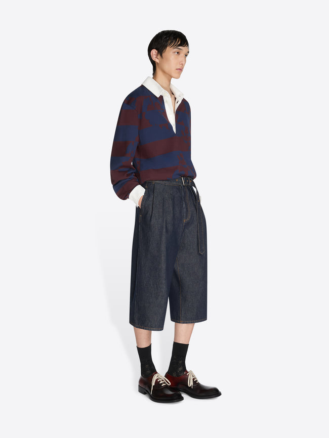 Person wearing a striped sweater and wide-leg pants on a white background - Dries Van Noten