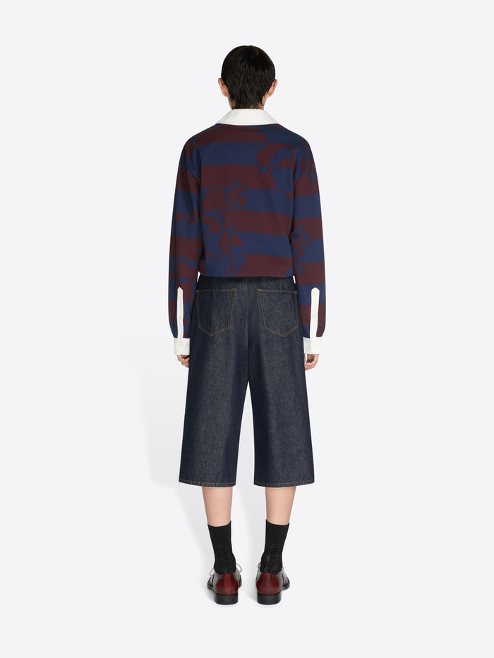 Person wearing a blue and red striped sweater with dark denim shorts on a white background - Dries Van Noten