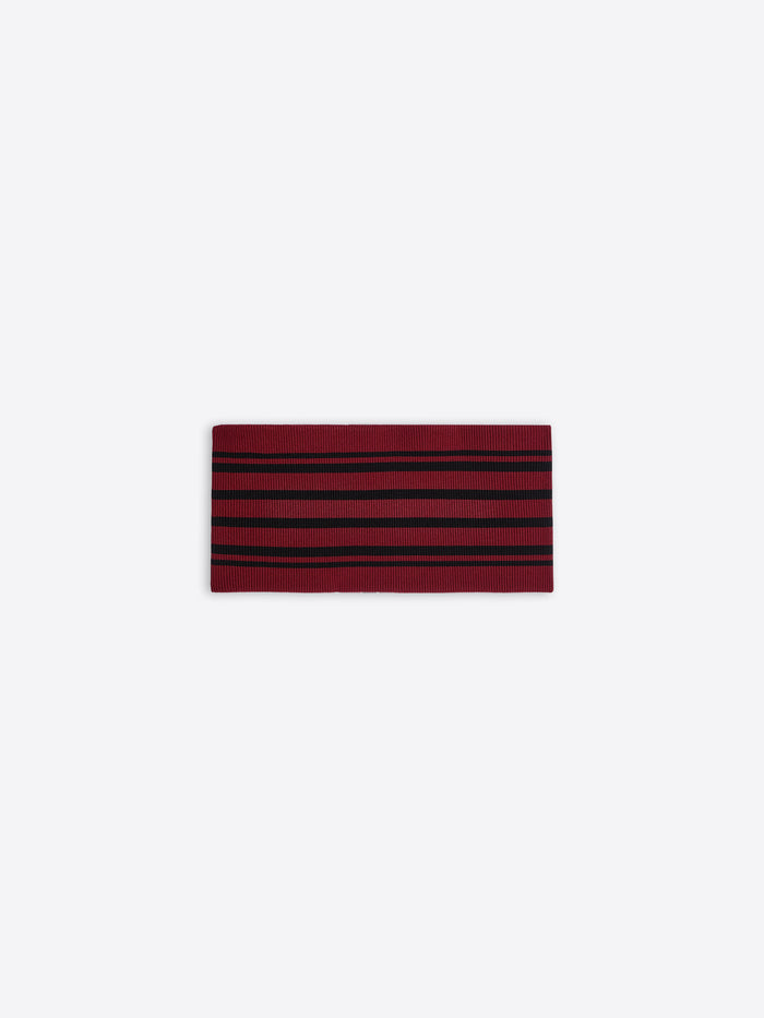 Red and black striped fabric belt on a white background