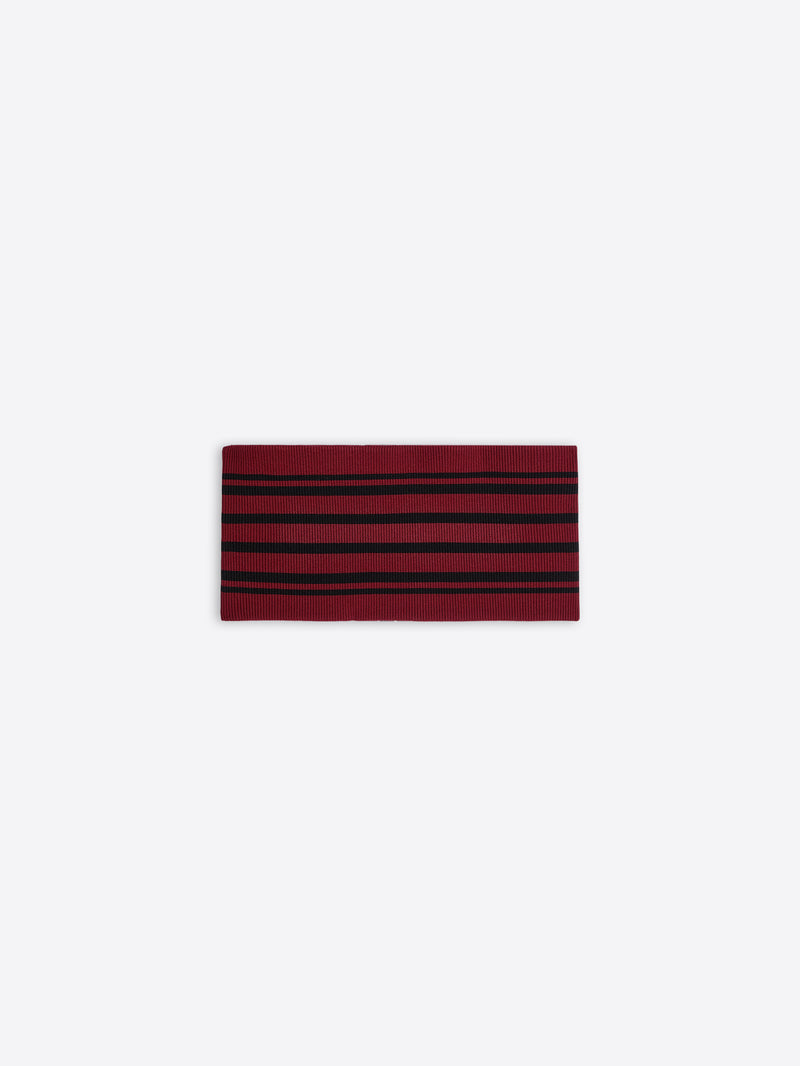 Red and black striped fabric belt on a white background