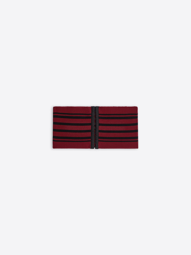 Red and black striped fabric belt on a white background