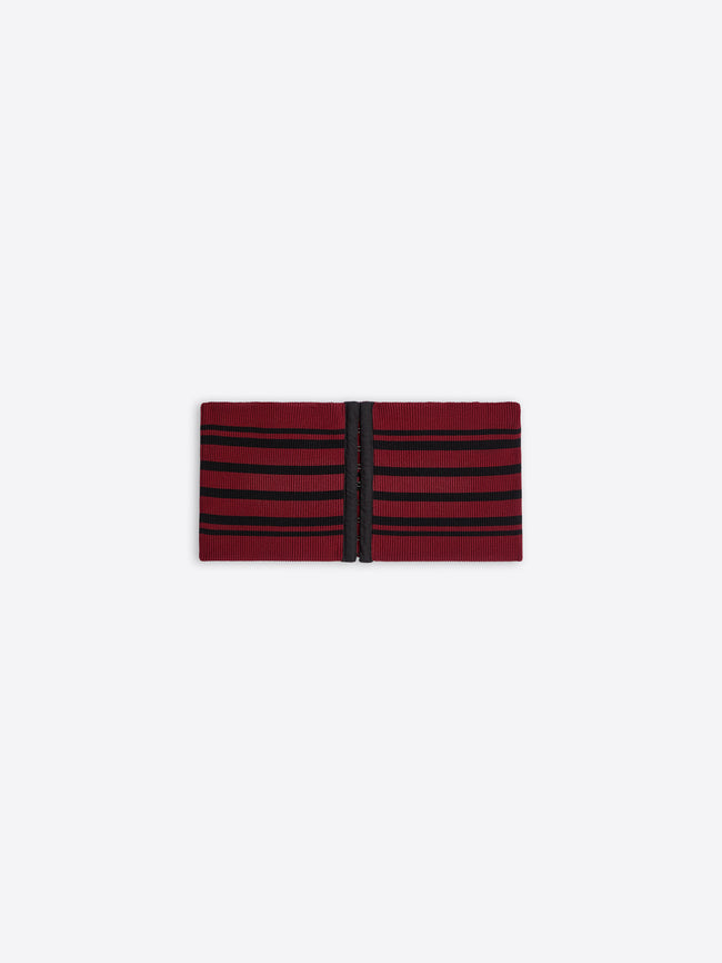 Red and black striped fabric belt on a white background