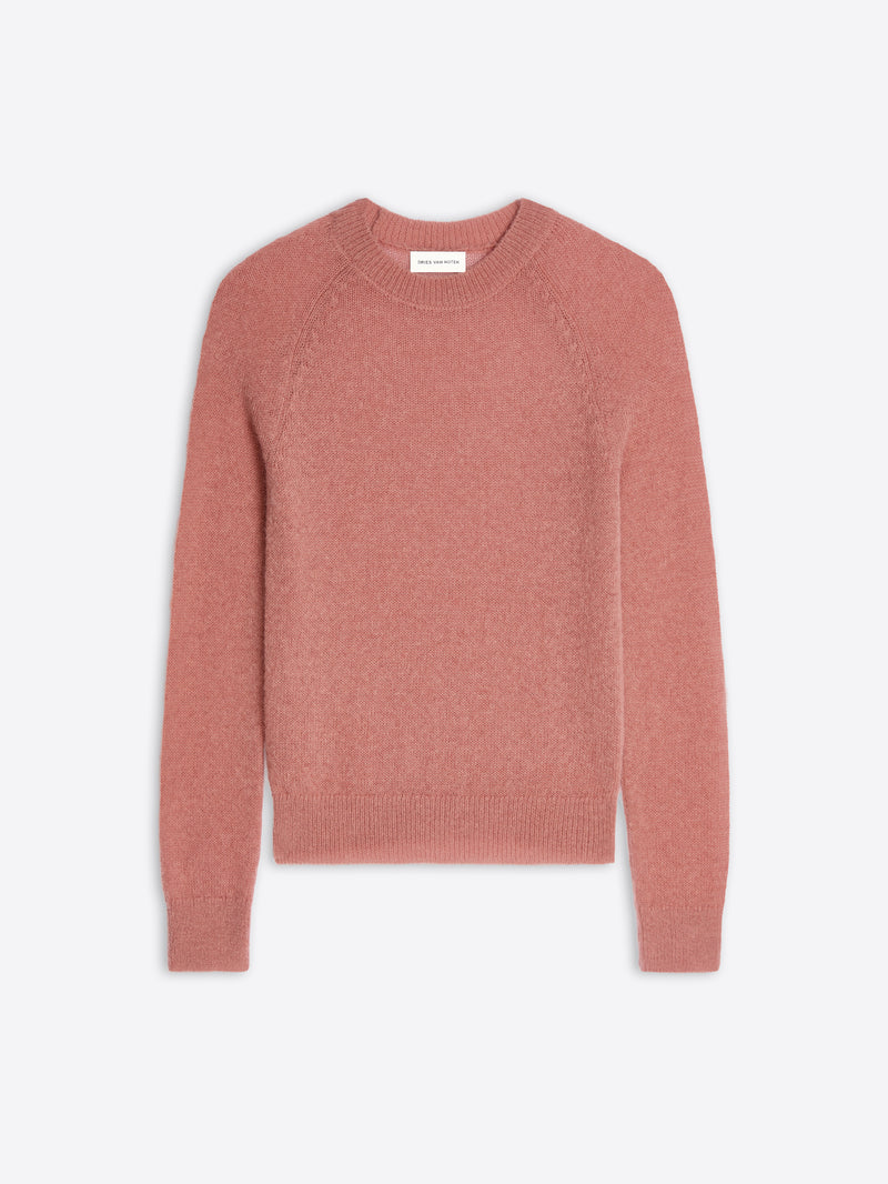Pink sweater on a light gray background