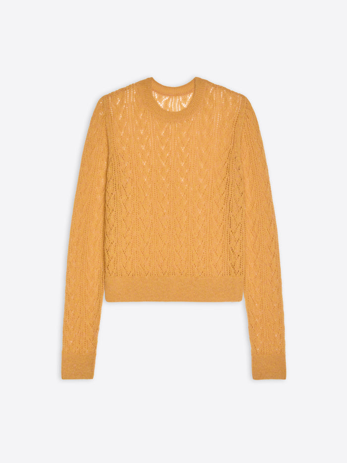Mustard yellow cable knit sweater on a light gray background