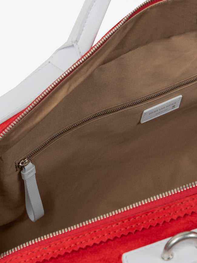 Close-up of a multicolored bag with a visible brand label. - Dries Van Noten