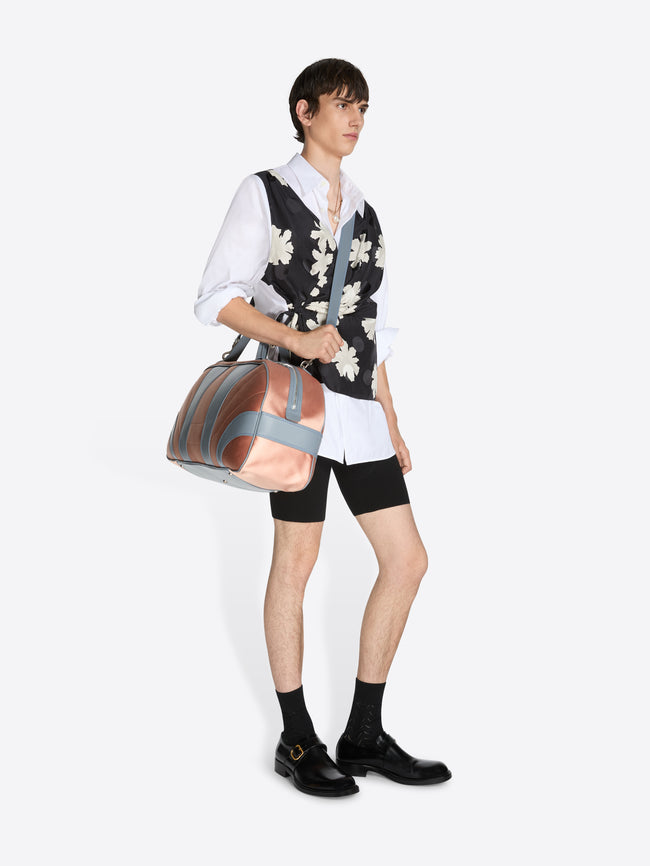 Person holding a handbag against a white background - Dries Van Noten